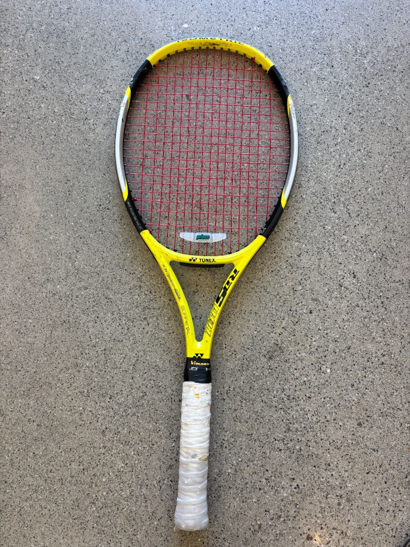 Yellow Yonex Tennis racquet with Prince dampener